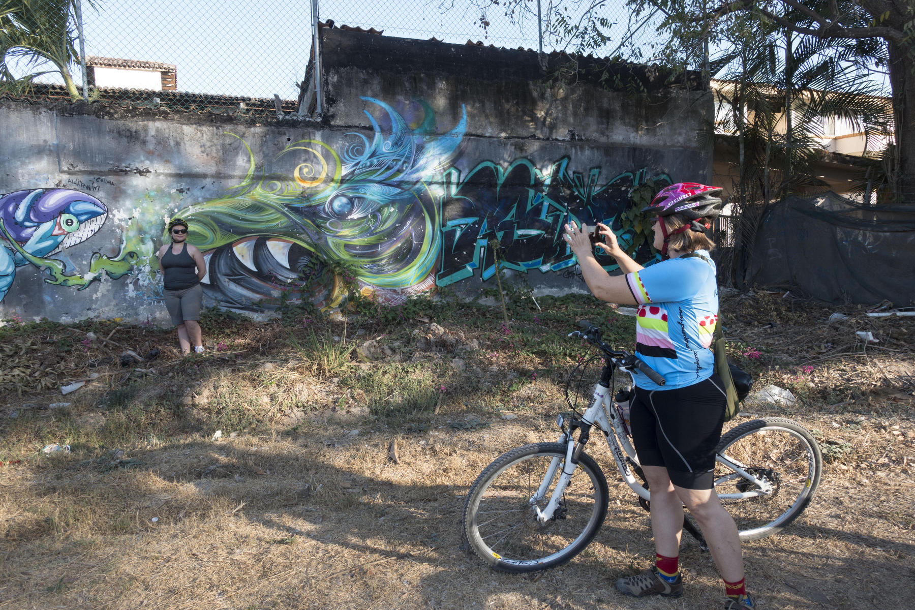 Carmen Poon taking a photo of bike tour participant Molly  : PUERTO VALLARTA - Wall Art & Bicycle Tour : Viviane Moos |  Documentary Photographer