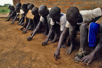 Their schools destroyed, no paper or pencils available, children  make do with learning to write in the sand. - © Viviane Moos