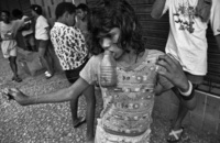 Fia floats in a glue induced high, her glue bottle hanging from her lips - © Viviane Moos