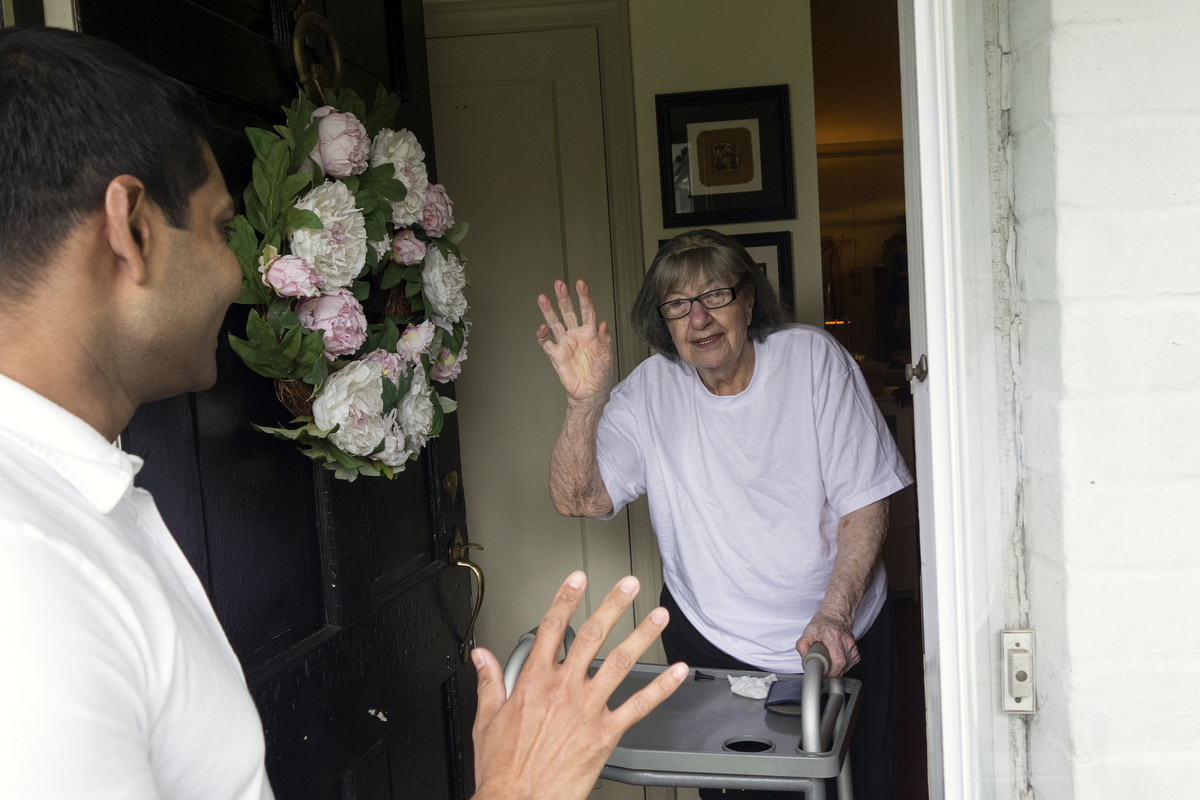 Dr. Nigel Verasami saying goodby to his patient Savina, after his monthly home visit. : FEATURE: Doctors making Home Visits : Viviane Moos |  Documentary Photographer