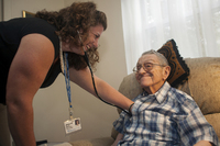 Nurse practitioner Jessica Giuseppi on her monthly visit to check on Robert, who can't walk and has problems speaking. - © Viviane Moos