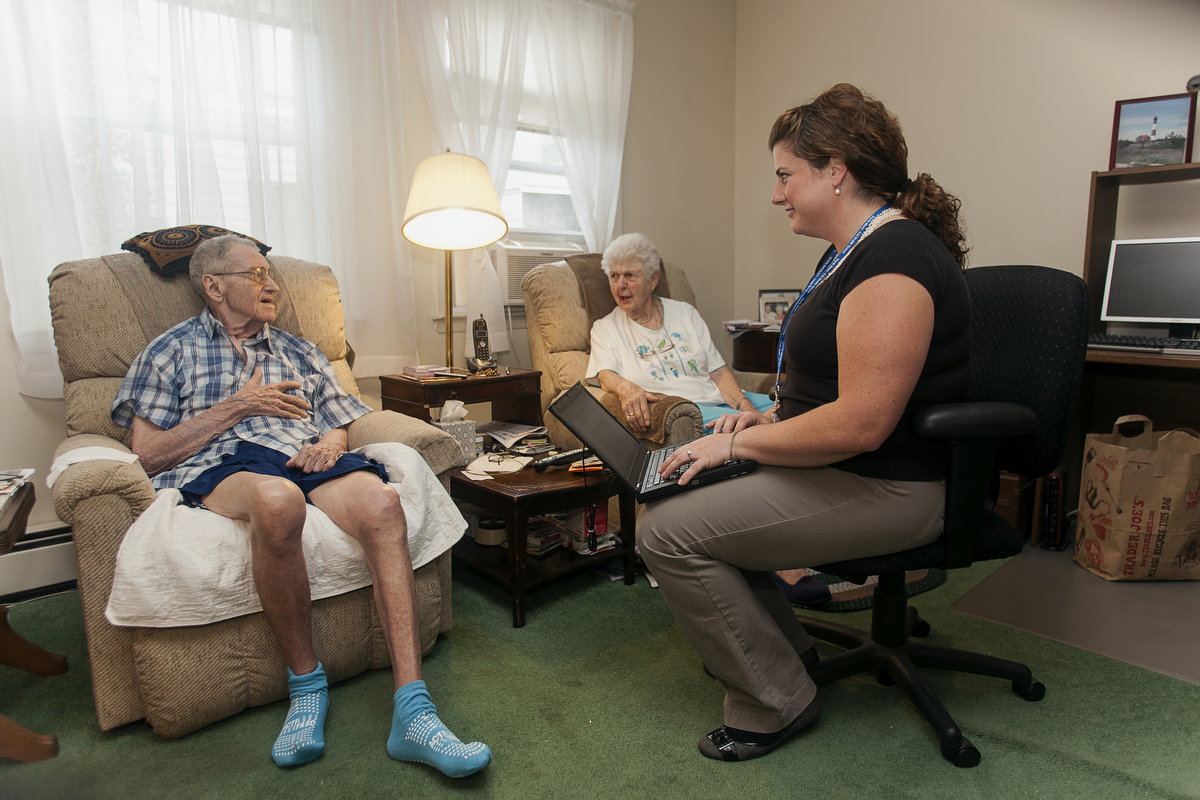 Nurse practitioner Jessica Giuseppi on her monthly home visit to check on Robert, who can't walk and has problems speaking. : FEATURE: Doctors making Home Visits : Viviane Moos |  Documentary Photographer