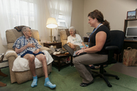 Nurse practitioner Jessica Giuseppi on her monthly home visit to check on Robert, who can't walk and has problems speaking. - © Viviane Moos