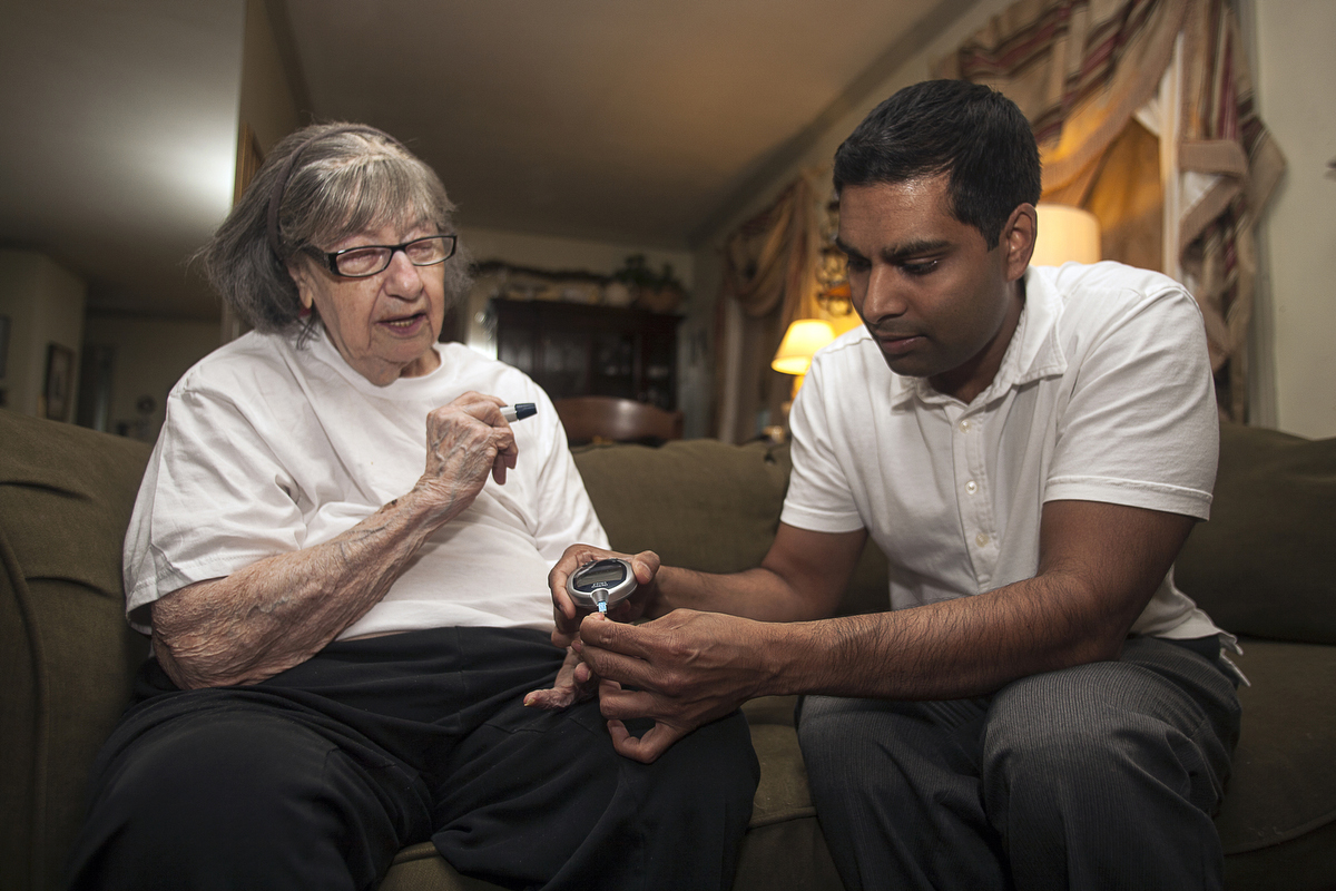 Dr. Nigel Verasami, on his monthly home visit, discovers that Savina, who is diabetic and can't walk, has not been using her blood sugar monitor correctly. : FEATURE: Doctors making Home Visits : Viviane Moos |  Documentary Photographer