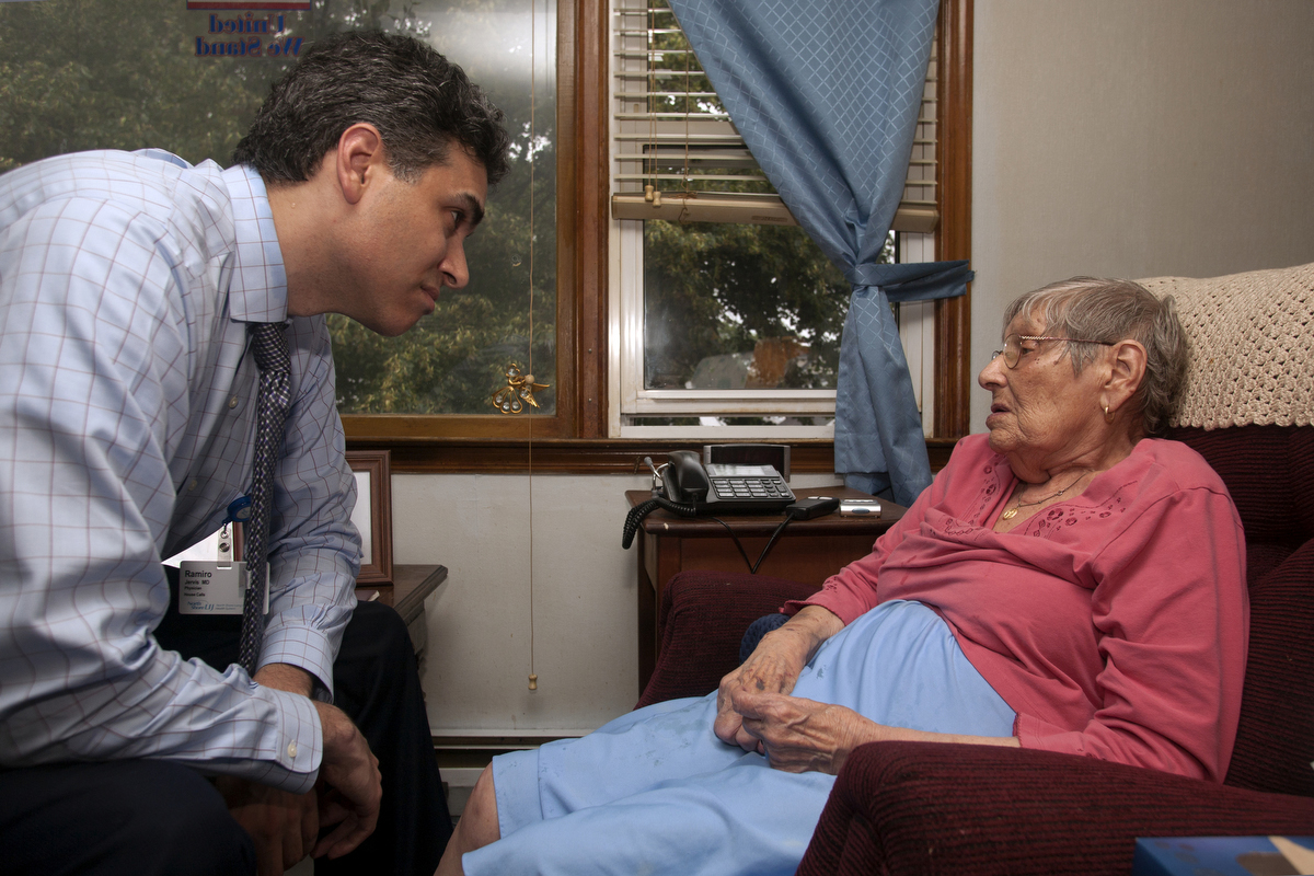 Dr. Ramiro Jervis shows his empathy and understanding to Dorothy, who is feeling helpless this morning, when she discovers she suddenly can't walk. : FEATURE: Doctors making Home Visits : Viviane Moos |  Documentary Photographer
