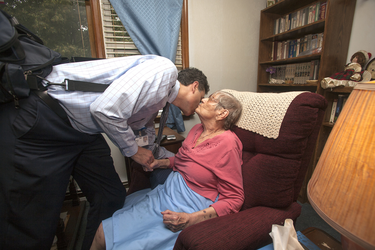 Dr. Ramiro Jervis gives and gets a goodbye kiss from his patient before he leaves. : FEATURE: Doctors making Home Visits : Viviane Moos |  Documentary Photographer