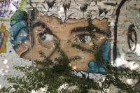 Mysterious painted eyes stare out from a park mural. - © Viviane Moos