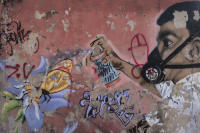 Wall painting depicting spraying a mosquito. Possibly a message about the Zika virus. - © Viviane Moos